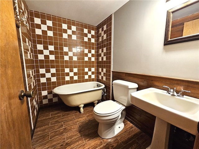 bathroom with tile walls, toilet, and wood-type flooring