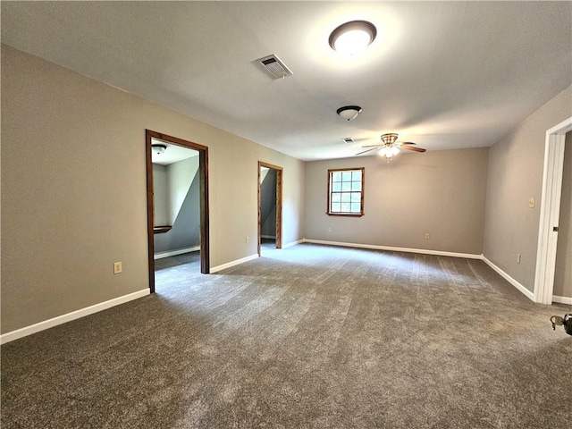 spare room featuring ceiling fan and dark carpet