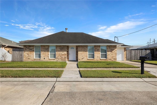 ranch-style house with a front lawn