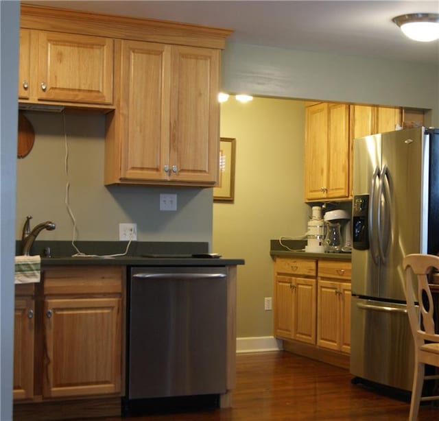 kitchen with dark hardwood / wood-style floors, stainless steel appliances, and sink