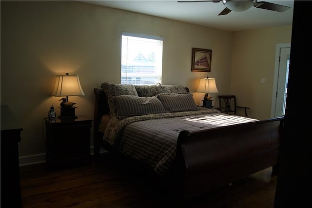 bedroom with ceiling fan and dark wood-type flooring