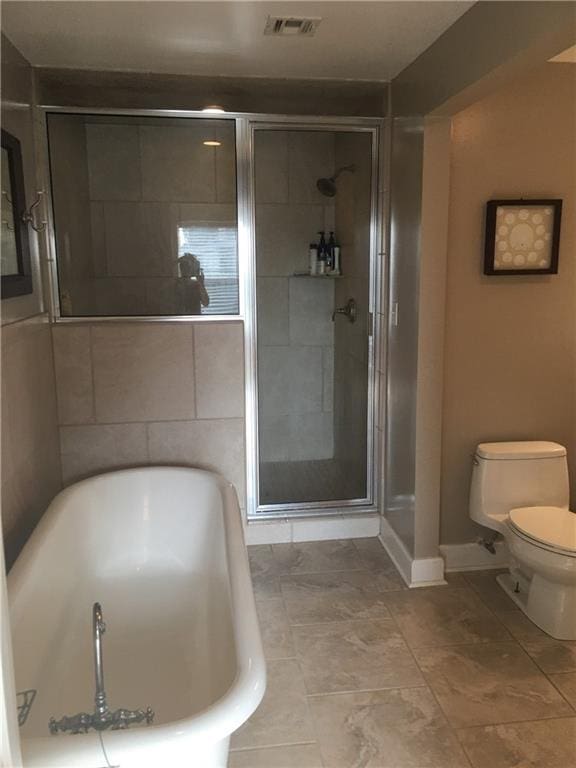 bathroom featuring toilet, plus walk in shower, and tile flooring