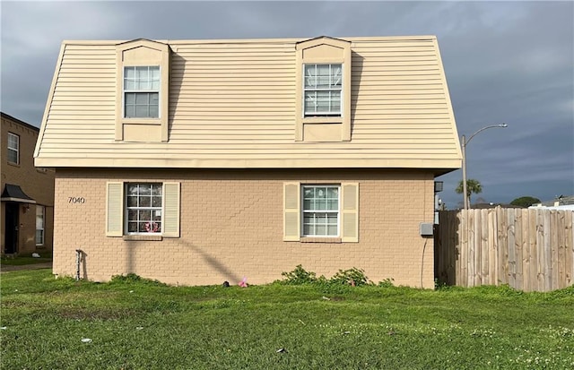 view of side of home featuring a lawn