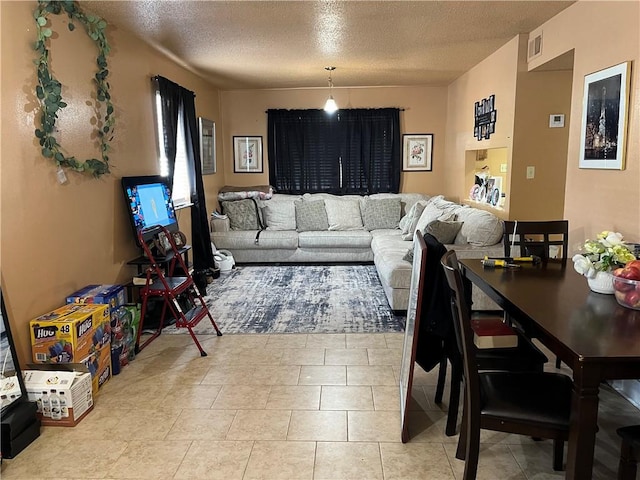 living room featuring tile floors and a textured ceiling