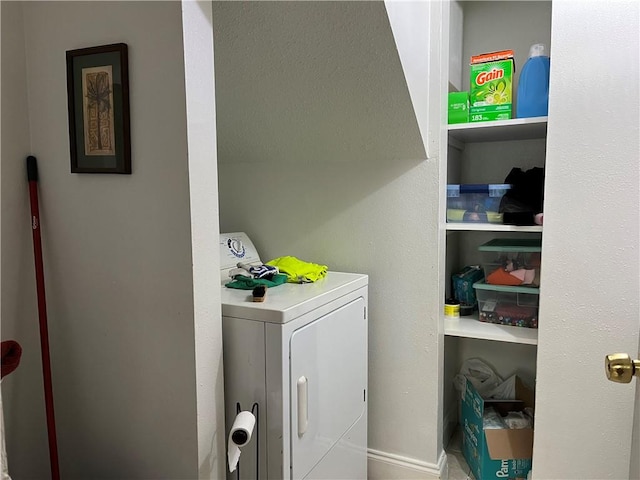 clothes washing area with washer / dryer and built in shelves