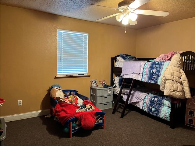 bedroom featuring ceiling fan, carpet floors, and a textured ceiling