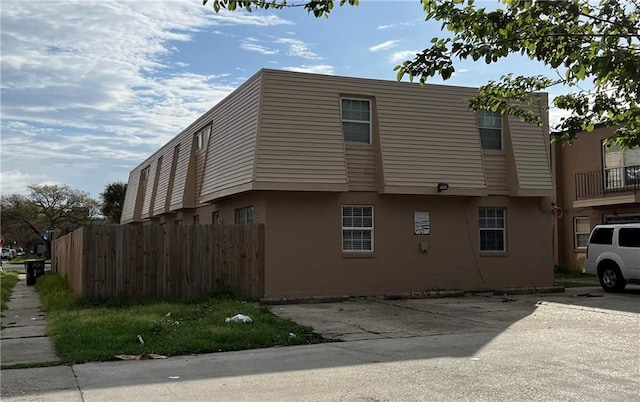 view of side of property featuring a balcony