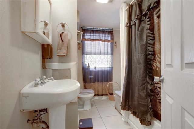 bathroom featuring toilet and tile floors