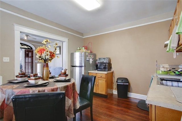 dining room with crown molding, dark hardwood / wood-style flooring, and ceiling fan