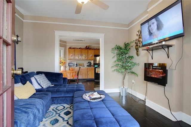 living room with dark wood-type flooring and ceiling fan