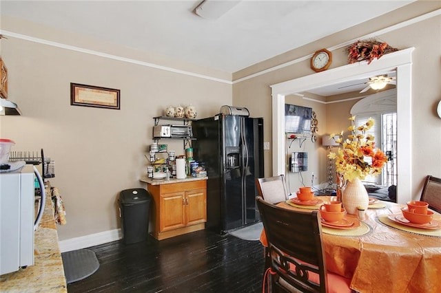 dining space featuring ceiling fan, dark wood-type flooring, and ornamental molding