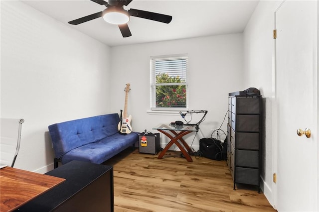 living area featuring ceiling fan and hardwood / wood-style flooring