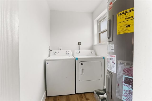 washroom featuring hardwood / wood-style floors, water heater, and independent washer and dryer