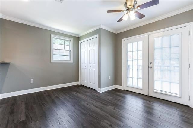 doorway with ornamental molding, ceiling fan, dark hardwood / wood-style floors, and french doors