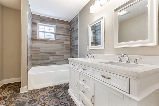 bathroom featuring dual vanity, tile floors, and tiled shower / bath