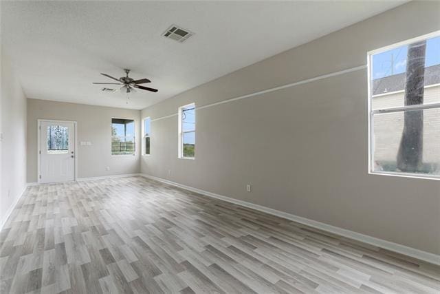 spare room featuring ceiling fan and light hardwood / wood-style flooring