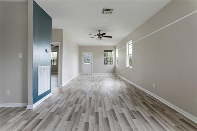 unfurnished room featuring light hardwood / wood-style floors and ceiling fan