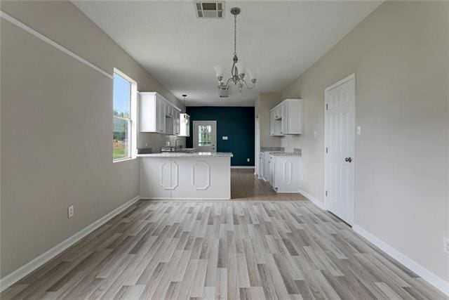 interior space with light hardwood / wood-style flooring and a notable chandelier