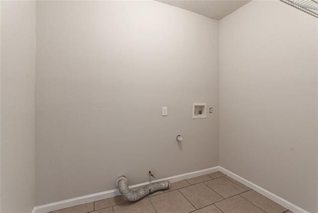 washroom with light tile floors, hookup for a gas dryer, and washer hookup