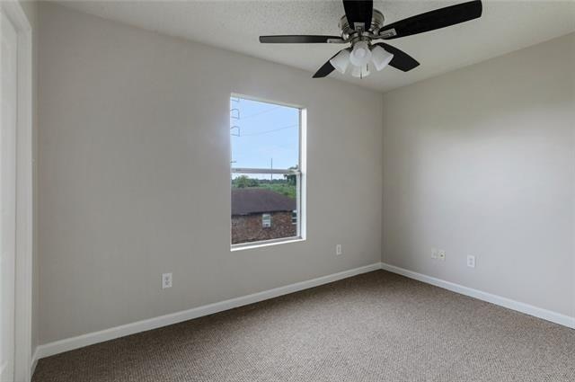 spare room featuring carpet and ceiling fan