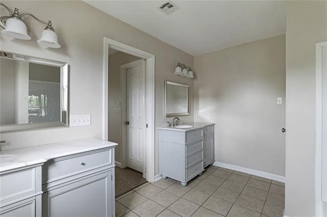 bathroom with tile flooring and vanity