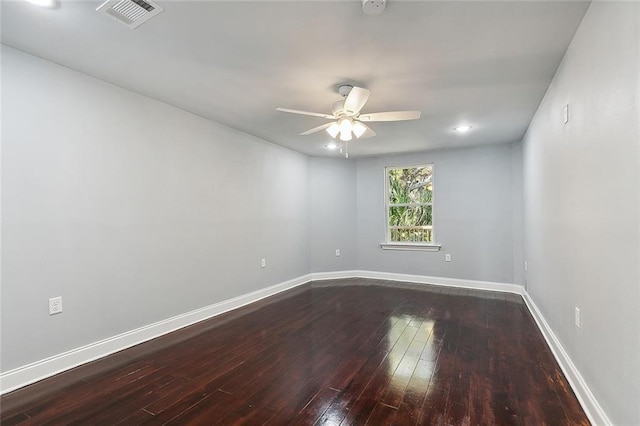 empty room with ceiling fan and dark hardwood / wood-style flooring