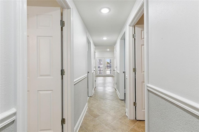 corridor featuring light tile floors