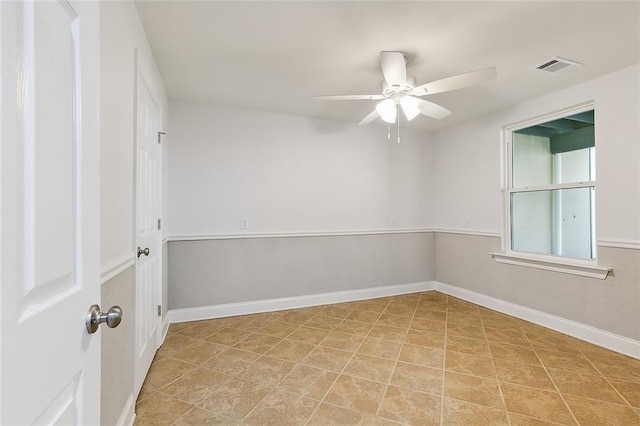 unfurnished room with light tile floors and ceiling fan