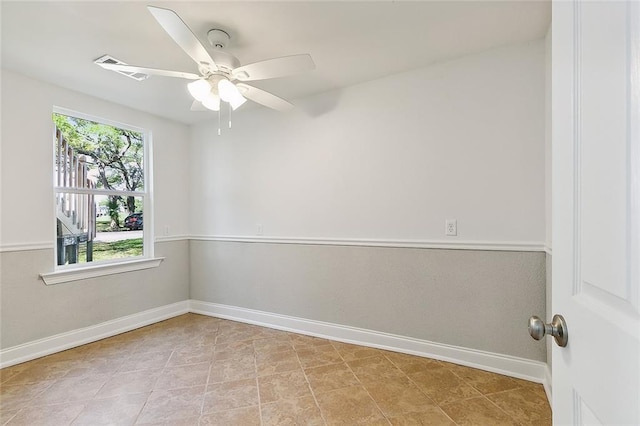 spare room with light tile flooring and ceiling fan