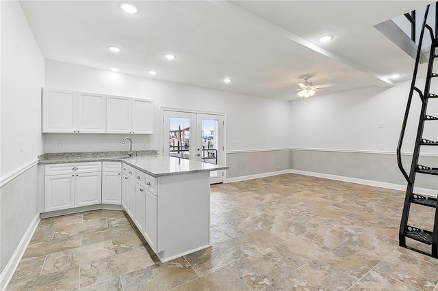 kitchen featuring light stone countertops, white cabinetry, ceiling fan, light tile floors, and french doors