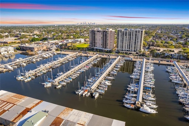 aerial view at dusk featuring a water view