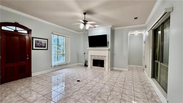 unfurnished living room with light tile floors, ornamental molding, and ceiling fan