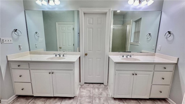 bathroom with vanity with extensive cabinet space and tile floors