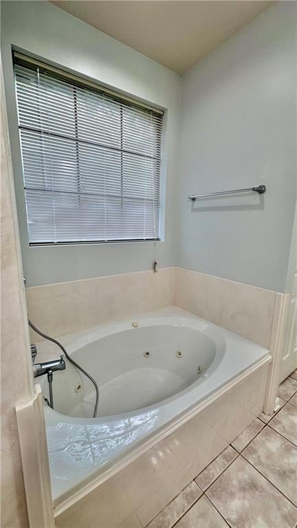 bathroom with a relaxing tiled bath and tile floors