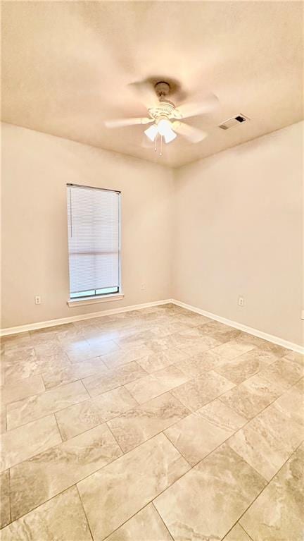 unfurnished room with light tile flooring and ceiling fan