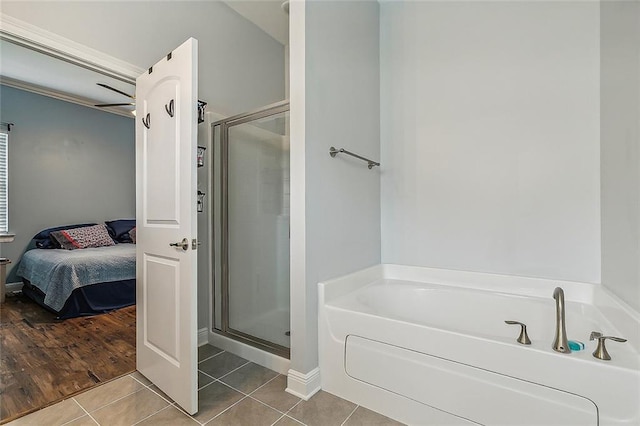 bathroom with tile patterned flooring and plus walk in shower