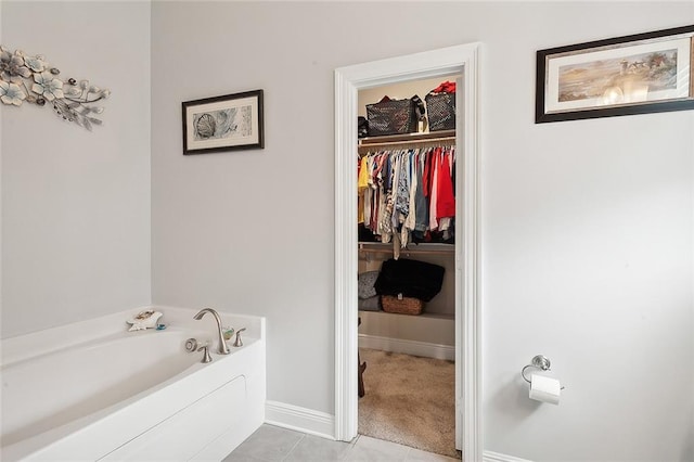 bathroom with a bathtub and tile patterned flooring