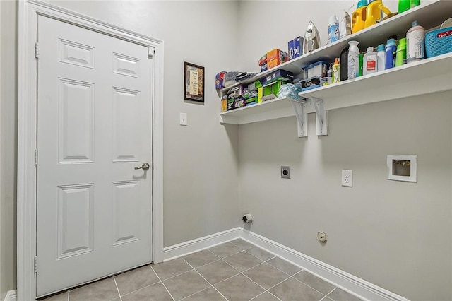 laundry area with hookup for an electric dryer, washer hookup, gas dryer hookup, and light tile patterned flooring