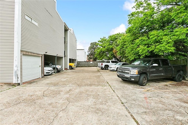 view of parking / parking lot with a garage