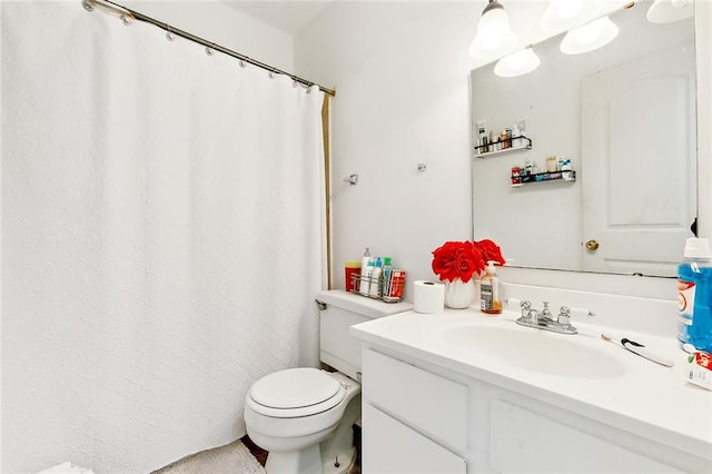 bathroom featuring toilet and vanity