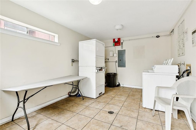 laundry room with light tile patterned flooring, electric panel, and stacked washer / dryer