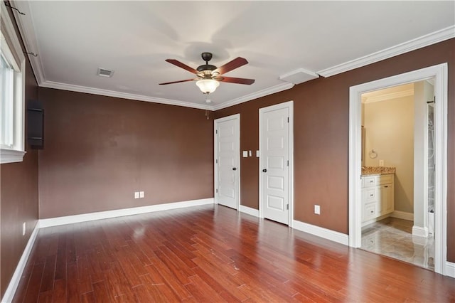 unfurnished bedroom featuring connected bathroom, ceiling fan, wood-type flooring, and ornamental molding