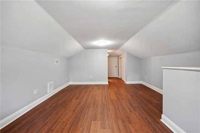 bonus room featuring dark hardwood / wood-style flooring and lofted ceiling