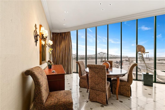 dining space with a wall of windows, ornamental molding, and light tile patterned floors