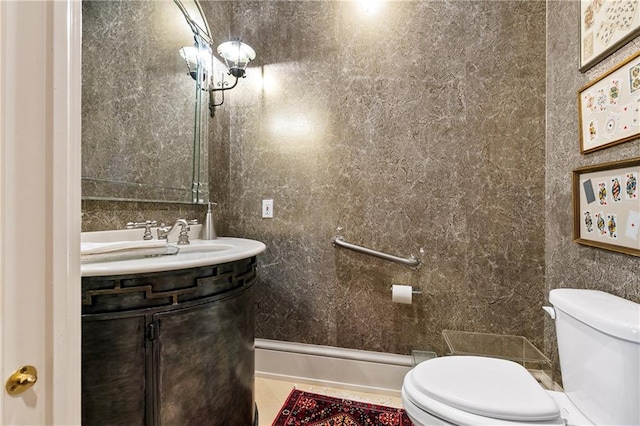 bathroom featuring tile walls, vanity, and toilet