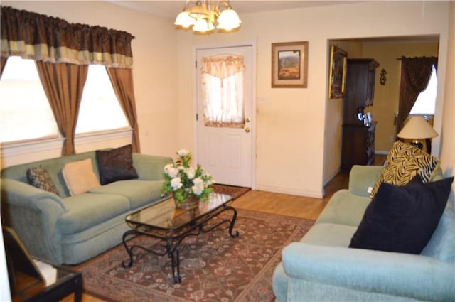 living room featuring hardwood / wood-style flooring and an inviting chandelier