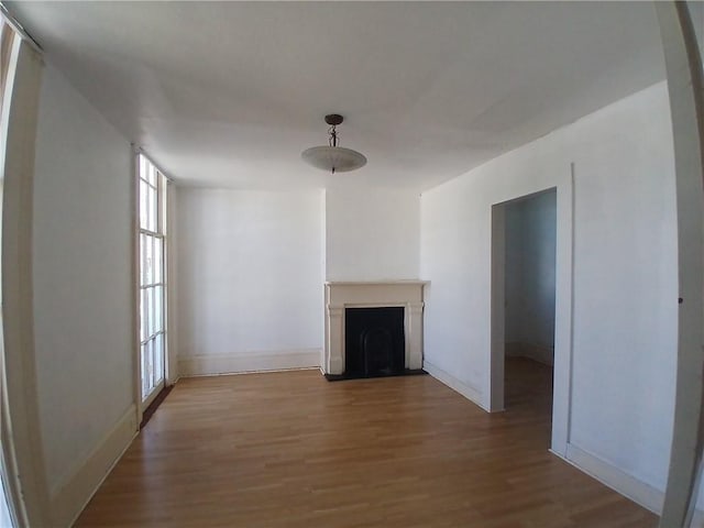 unfurnished living room with a healthy amount of sunlight and light wood-type flooring