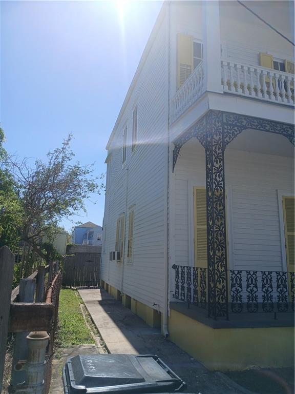 1322 Kerlerec St, New Orleans, LA 70116 - view of home's exterior with a balcony and fence