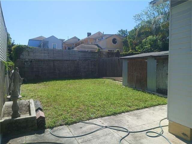 1322 Kerlerec St, New Orleans, LA 70116 - view of yard with an outbuilding, a storage unit, and a patio area