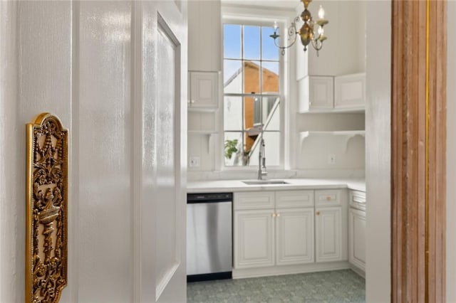 bar with white cabinetry, sink, stainless steel dishwasher, and a notable chandelier